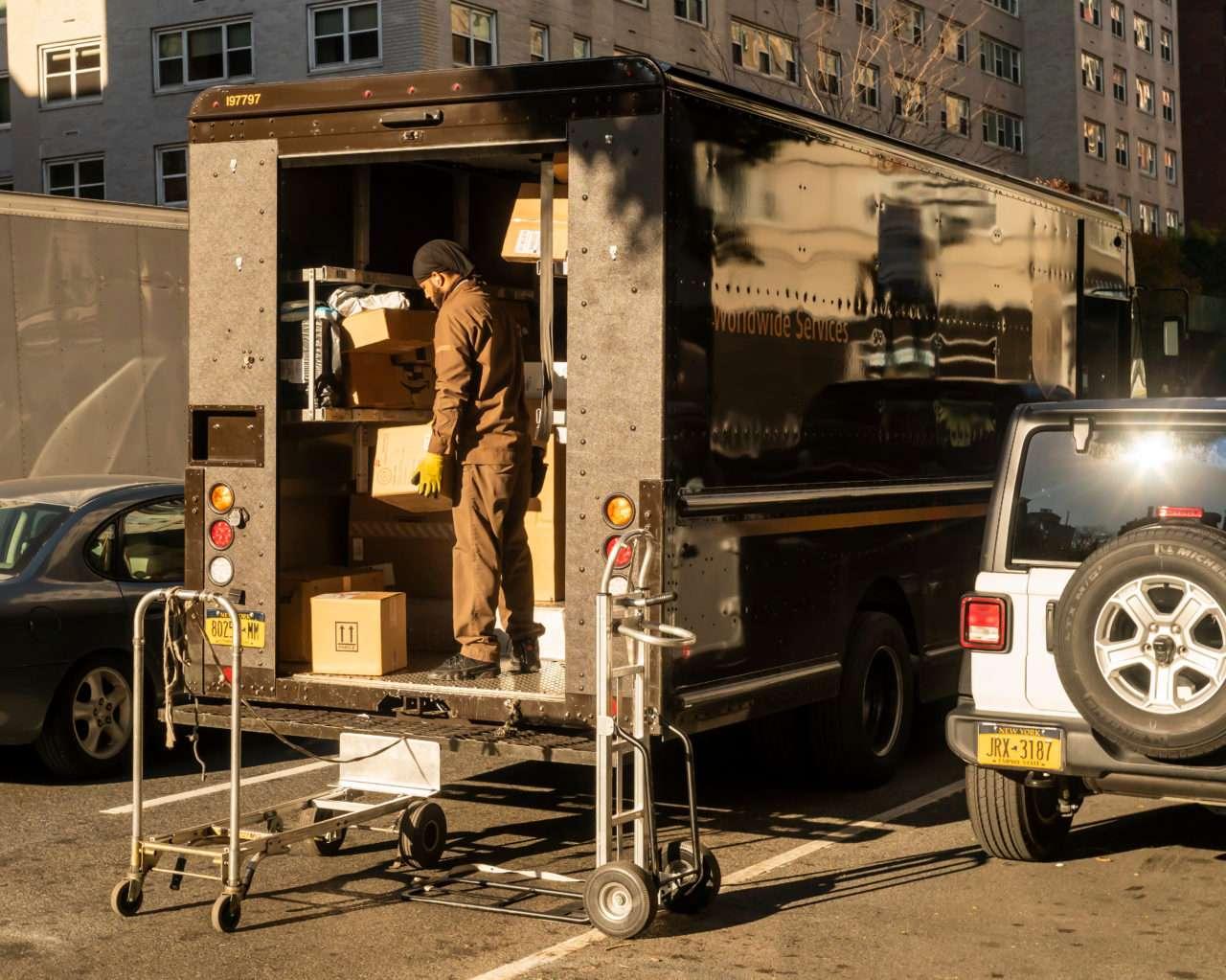 Deliveryman From Ups Sorts Packages