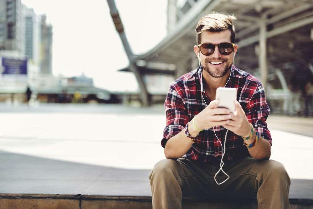 Man enjoys listening to music on his smartphone
