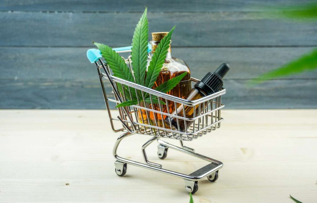 Supermarket Trolley With Marijuana Leaf And Medical Cannabis Oil CBD