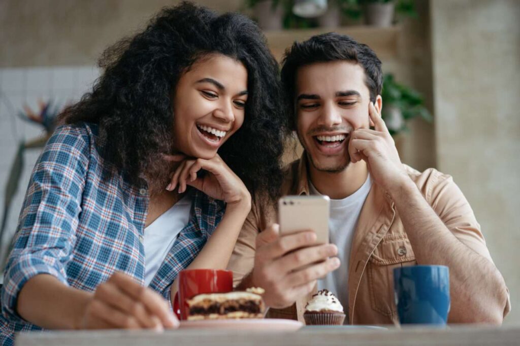 Couple watches a viral video on their phone.