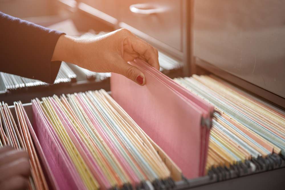 Woman Getting Files from a Filing Cabinet